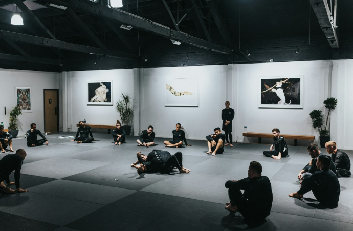 people sitting on floor in front of white wall